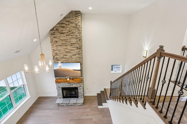 6807 Kew Gdn, Smyrna, TN 37167 - stairway featuring wood finished floors, high vaulted ceiling, a fireplace, a chandelier, and recessed lighting