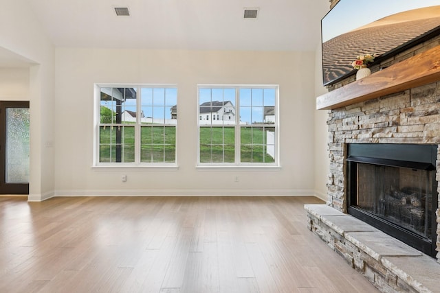 6807 Kew Gdn, Smyrna, TN 37167 - unfurnished living room with wood finished floors, healthy amount of natural light, and a fireplace