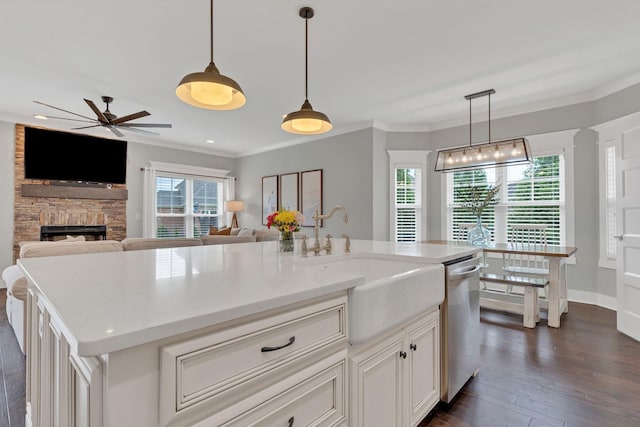 1924 Fairhaven Ln, Murfreesboro, TN 37128 - kitchen with dishwasher, a fireplace, a ceiling fan, crown molding, and dark wood-style flooring