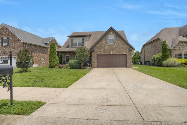 1248 Hensfield Dr, Murfreesboro, TN 37128 - view of front facade with concrete driveway, brick siding, and a front yard
