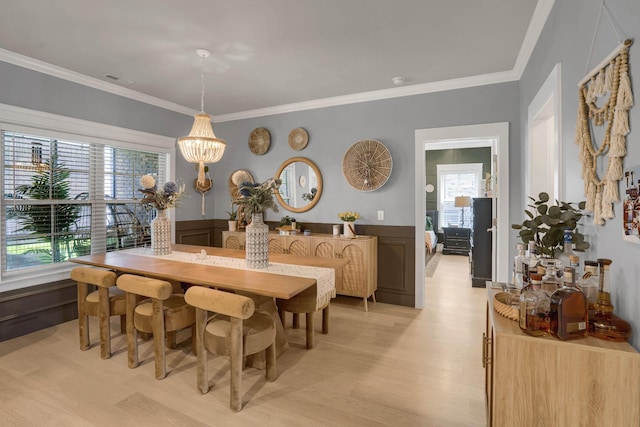 1248 Hensfield Dr, Murfreesboro, TN 37128 - dining room featuring light wood-style flooring, wainscoting, crown molding, a chandelier, and a decorative wall