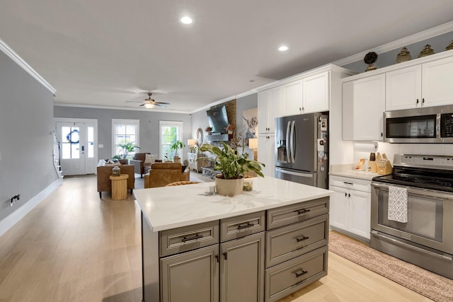 1248 Hensfield Dr, Murfreesboro, TN 37128 - kitchen featuring stainless steel appliances, ornamental molding, a ceiling fan, white cabinets, and light wood-style floors