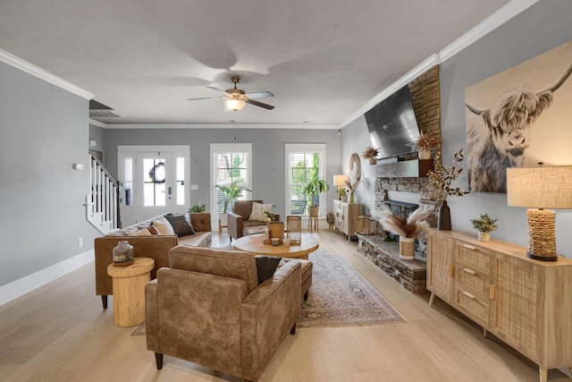 1248 Hensfield Dr, Murfreesboro, TN 37128 - living room with light wood-style floors, ceiling fan, stairway, crown molding, and a stone fireplace