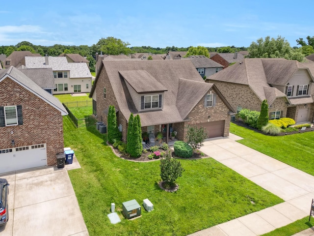 1248 Hensfield Dr, Murfreesboro, TN 37128 - view of front facade with concrete driveway, brick siding, a residential view, and a front yard