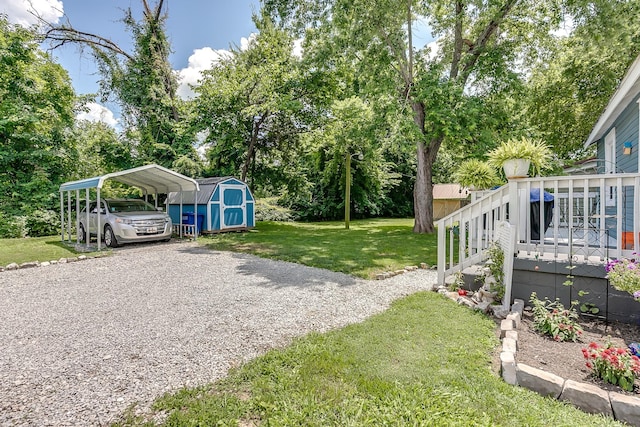 106 S Locust St S, Mount Pleasant, TN 38474 - view of green lawn with a storage shed, a carport, a deck, view of scattered trees, and driveway