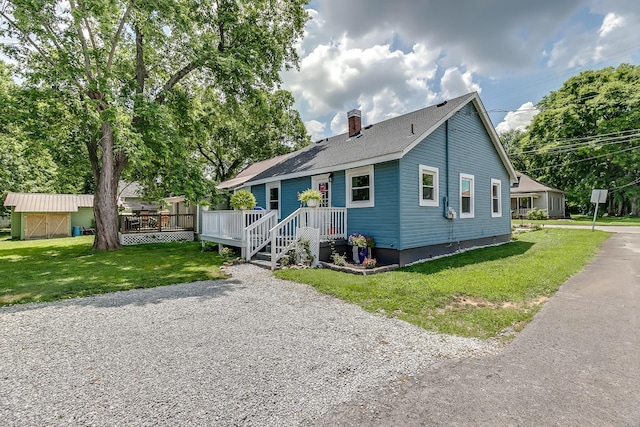 106 S Locust St S, Mount Pleasant, TN 38474 - bungalow with a chimney, a front lawn, a deck, and an outdoor structure