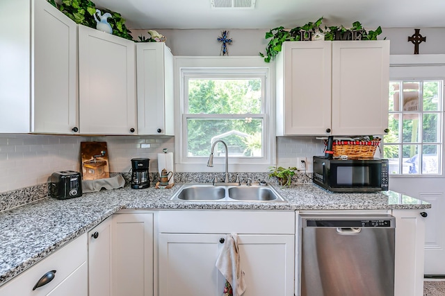 106 S Locust St S, Mount Pleasant, TN 38474 - kitchen with stainless steel dishwasher, black microwave, backsplash, and white cabinets