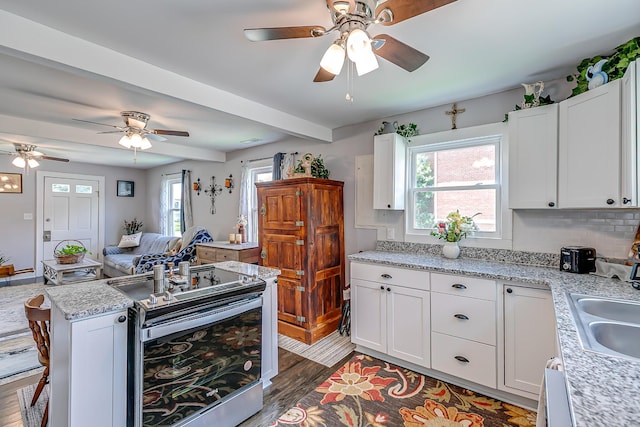106 S Locust St S, Mount Pleasant, TN 38474 - kitchen with stainless steel range with electric cooktop, a ceiling fan, wood finished floors, open floor plan, and beamed ceiling