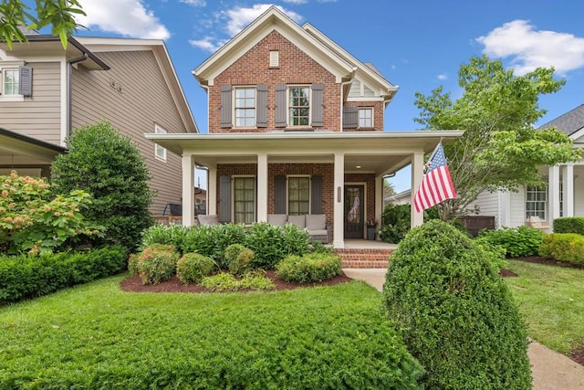 1322 Jewell Ave, Franklin, TN 37064 - view of front of property featuring brick siding, covered porch, and a front yard