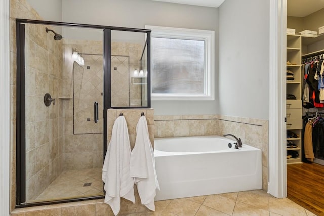 1322 Jewell Ave, Franklin, TN 37064 - bathroom with a garden tub, a walk in closet, a stall shower, and tile patterned flooring