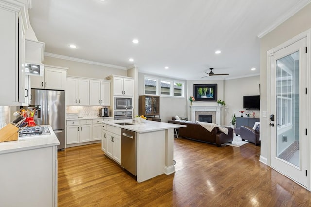 1322 Jewell Ave, Franklin, TN 37064 - kitchen with stainless steel appliances, light countertops, white cabinets, tasteful backsplash, and crown molding