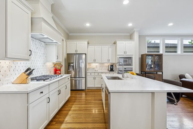 1322 Jewell Ave, Franklin, TN 37064 - kitchen featuring stainless steel appliances, ornamental molding, wood finished floors, light countertops, and premium range hood