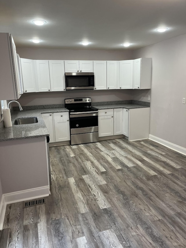 918 Velma Ln, Murfreesboro, TN 37129 - kitchen with stainless steel appliances, white cabinets, dark wood-style floors, recessed lighting, and stone counters
