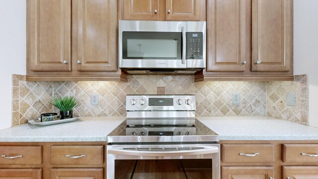 3325 Geneva Dr, Murfreesboro, TN 37128 - kitchen with stainless steel appliances, tasteful backsplash, and light stone counters