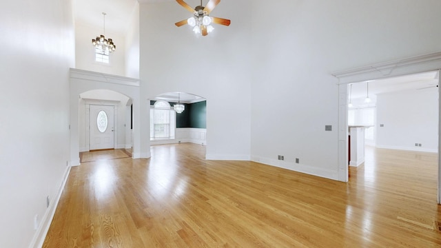 3325 Geneva Dr, Murfreesboro, TN 37128 - entrance foyer featuring a chandelier, a ceiling fan, a high ceiling, arched walkways, and light wood-style floors