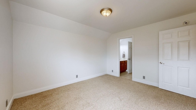 3325 Geneva Dr, Murfreesboro, TN 37128 - unfurnished bedroom featuring light colored carpet, lofted ceiling, and ensuite bathroom
