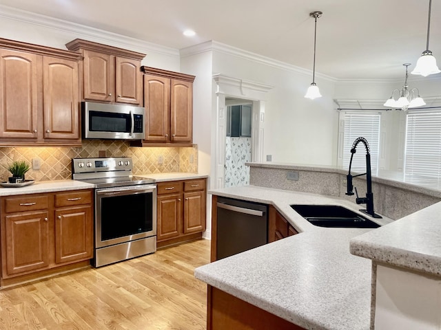 3325 Geneva Dr, Murfreesboro, TN 37128 - kitchen with stainless steel appliances, light wood-style flooring, hanging light fixtures, crown molding, and a chandelier