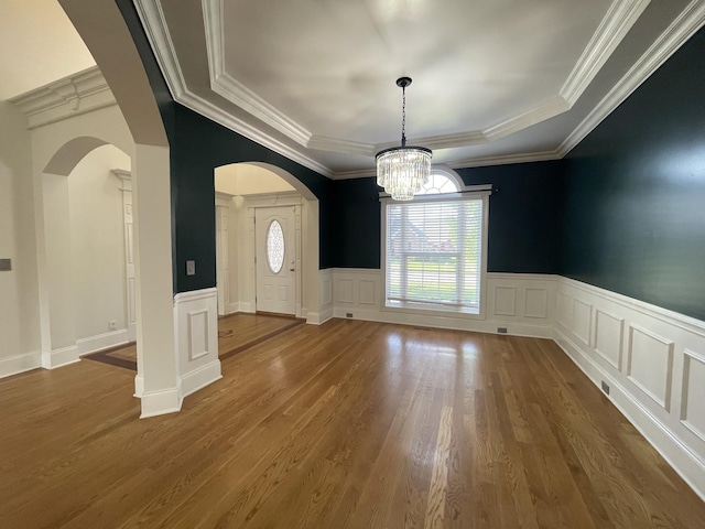 3325 Geneva Dr, Murfreesboro, TN 37128 - unfurnished dining area featuring a chandelier, a decorative wall, dark wood finished floors, a wainscoted wall, and ornamental molding