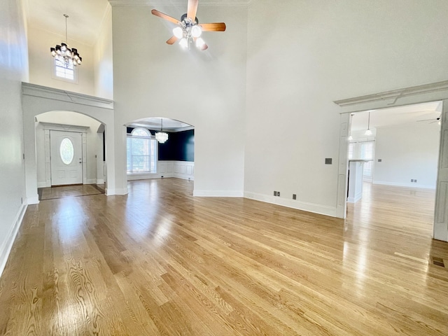 3325 Geneva Dr, Murfreesboro, TN 37128 - foyer entrance with ceiling fan, a chandelier, a high ceiling, arched walkways, and light wood-style floors