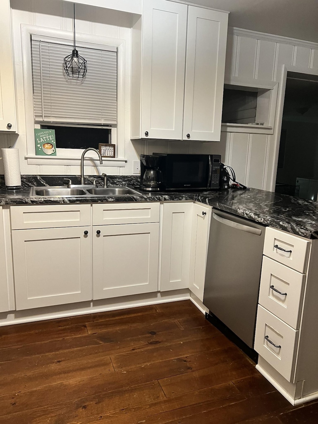 1109 N Charlotte St, Dickson, TN 37055 - kitchen featuring stainless steel dishwasher, black microwave, dark wood finished floors, and white cabinets
