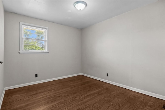 1109 N Charlotte St, Dickson, TN 37055 - spare room featuring dark wood-type flooring and baseboards