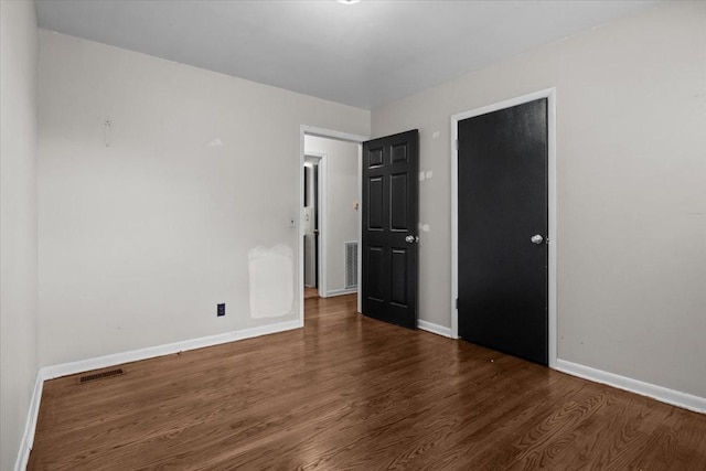 1109 N Charlotte St, Dickson, TN 37055 - unfurnished bedroom with wood finished floors and baseboards