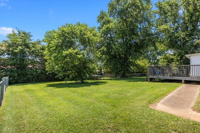 1109 N Charlotte St, Dickson, TN 37055 - view of yard with a trampoline, a deck, and view of scattered trees