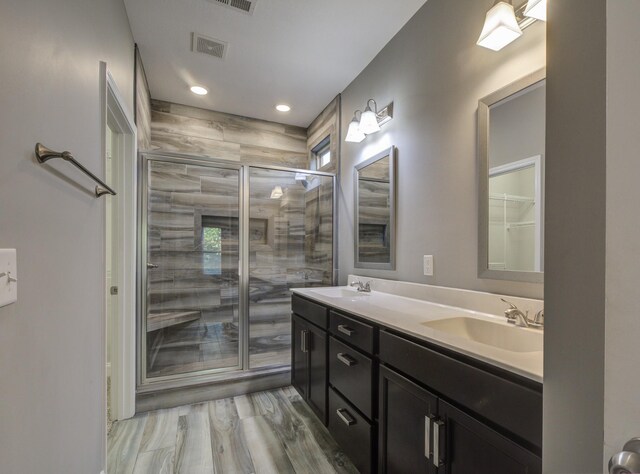 203 Eagles Talon Ct, Clarksville, TN 37040 - full bathroom with double vanity, a stall shower, recessed lighting, and wood finished floors