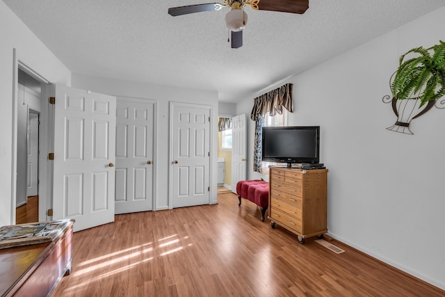 6434 Waconda Point Rd, Harrison, TN 37341 - bedroom with a textured ceiling, light wood-style floors, and ceiling fan