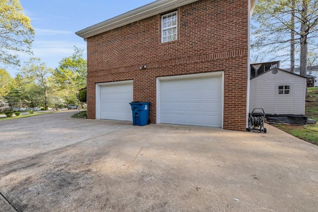 6434 Waconda Point Rd, Harrison, TN 37341 - view of home's exterior with brick siding, a garage, and concrete driveway