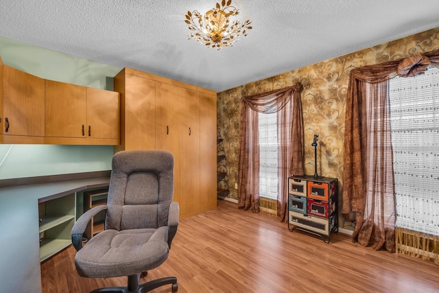6434 Waconda Point Rd, Harrison, TN 37341 - home office featuring light wood finished floors, a textured ceiling, and wallpapered walls