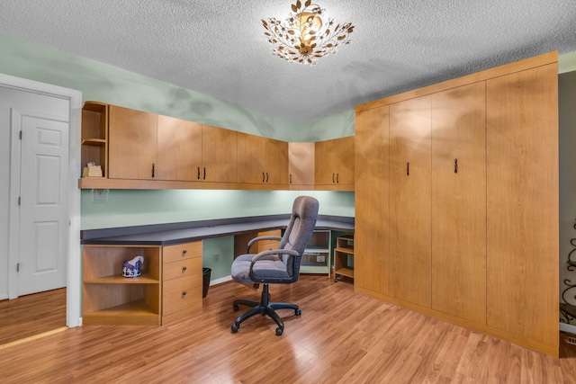 6434 Waconda Point Rd, Harrison, TN 37341 - office space with light wood-type flooring, a textured ceiling, and built in desk
