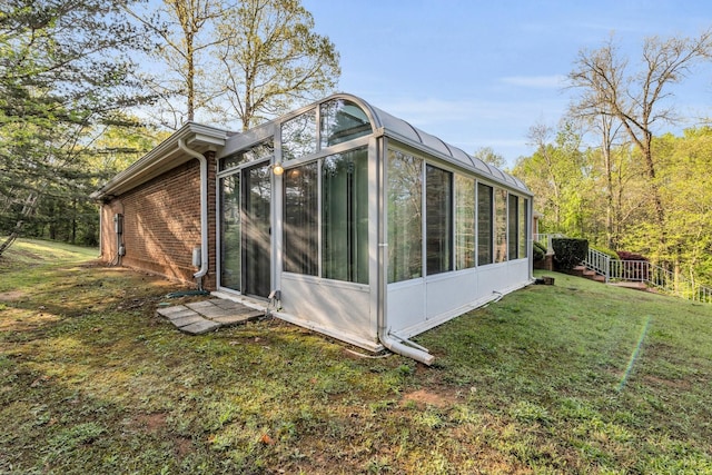 6434 Waconda Point Rd, Harrison, TN 37341 - view of side of property featuring a sunroom, brick siding, and a lawn