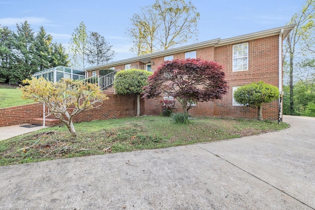 6434 Waconda Point Rd, Harrison, TN 37341 - view of front facade featuring a sunroom and brick siding
