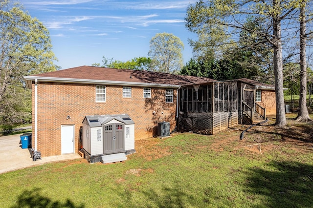 6434 Waconda Point Rd, Harrison, TN 37341 - back of house with a sunroom, brick siding, a yard, and a storage shed