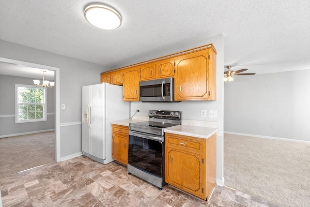 876 Gordon Pl, Clarksville, TN 37042 - kitchen featuring appliances with stainless steel finishes, a chandelier, light countertops, light carpet, and a textured ceiling