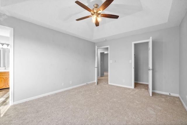 876 Gordon Pl, Clarksville, TN 37042 - unfurnished bedroom with carpet flooring, a tray ceiling, connected bathroom, and ceiling fan
