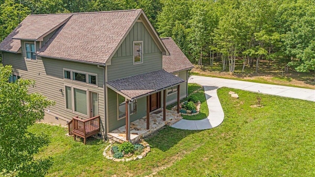 220 Bear Crawl Rd Unit Rb 28, Jasper, TN 37347 - view of side of property featuring board and batten siding, a yard, a shingled roof, and a porch