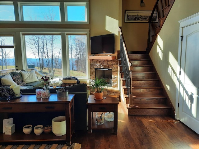 220 Bear Crawl Rd Unit Rb 28, Jasper, TN 37347 - living room featuring wood finished floors, stairs, healthy amount of natural light, a stone fireplace, and a high ceiling