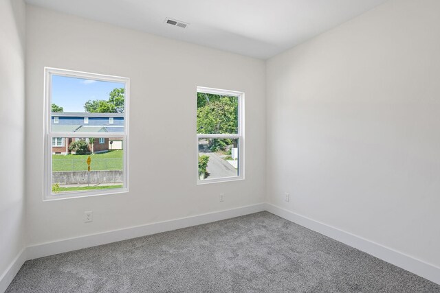 2140 18th Ave N, Nashville, TN 37208 - carpeted empty room with plenty of natural light