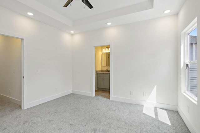 2140 18th Ave N, Nashville, TN 37208 - unfurnished bedroom featuring light colored carpet, recessed lighting, a raised ceiling, ensuite bathroom, and a ceiling fan