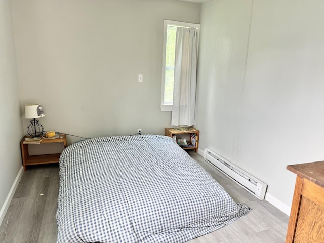 1812 13th St E, Chattanooga, TN 37404 - bedroom featuring a baseboard radiator and wood finished floors