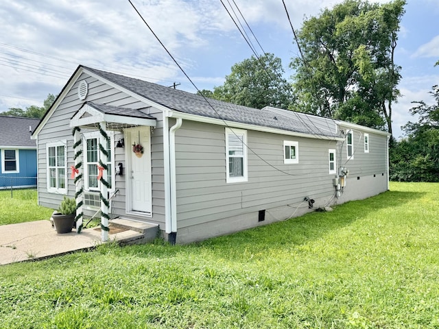 1812 13th St E, Chattanooga, TN 37404 - view of home's exterior with a yard, a shingled roof, and crawl space