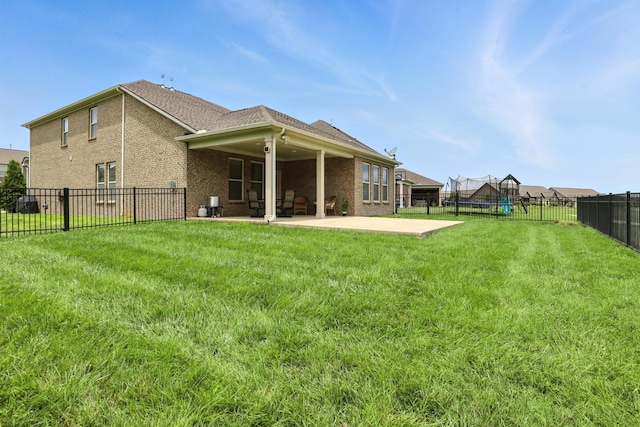 3154 Rift Ln, Murfreesboro, TN 37130 - rear view of house with a trampoline, a patio area, a fenced backyard, and brick siding