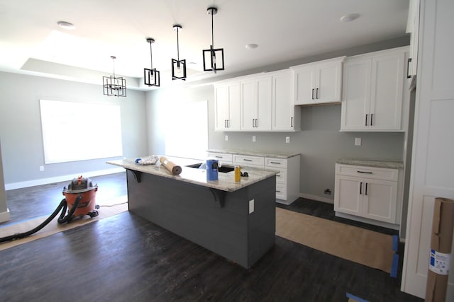 333 Brinkley Rd, Wartrace, TN 37183 - kitchen featuring dark wood-style flooring, white cabinetry, a kitchen island with sink, and light stone countertops