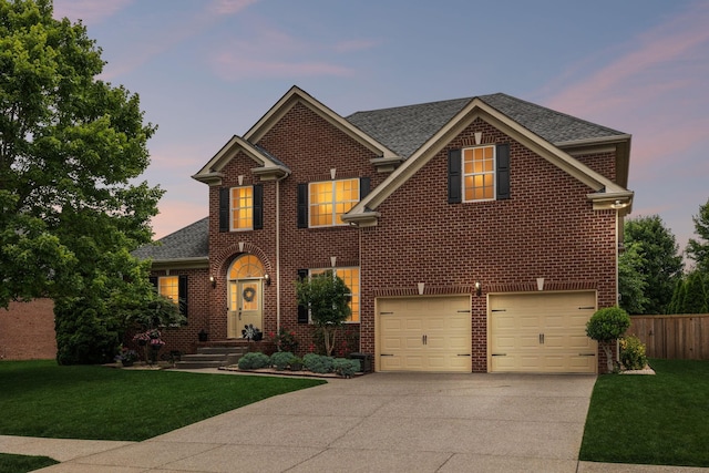 1011 Brixworth Dr, Thompsons Station, TN 37179 - view of front facade with driveway, an attached garage, brick siding, and a shingled roof