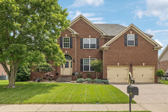 1011 Brixworth Dr, Thompsons Station, TN 37179 - view of front of property with concrete driveway, an attached garage, a front lawn, and brick siding