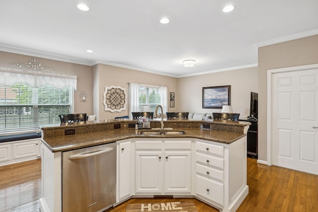 1011 Brixworth Dr, Thompsons Station, TN 37179 - kitchen featuring dishwasher, ornamental molding, dark stone counters, a kitchen island with sink, and white cabinets