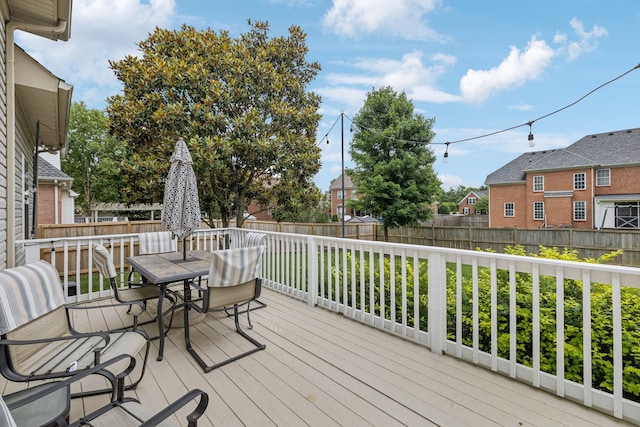 1011 Brixworth Dr, Thompsons Station, TN 37179 - wooden terrace with outdoor dining area and a fenced backyard