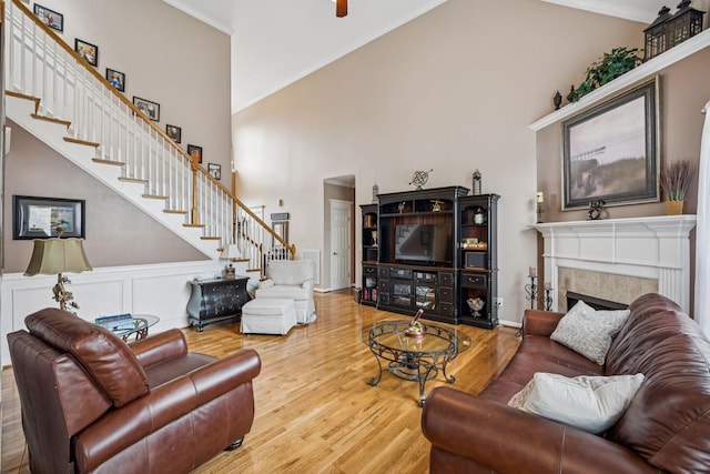 1011 Brixworth Dr, Thompsons Station, TN 37179 - living area with stairs, high vaulted ceiling, wood finished floors, a fireplace, and crown molding
